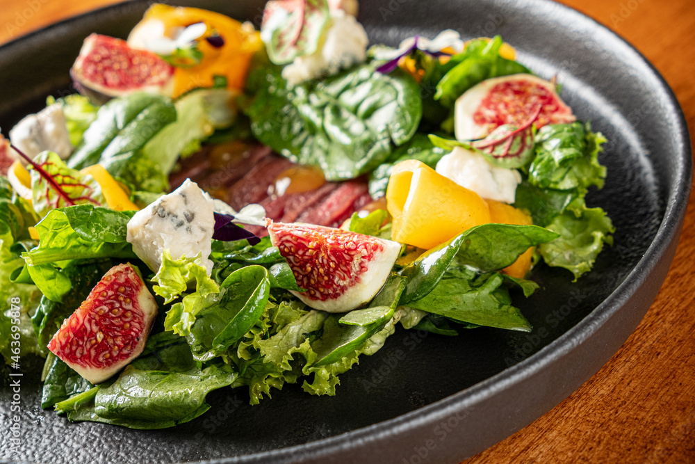 Italian gourmet salad with prosciutto, cheese and figs Italian gourmet salad with prosciutto, cheese and figs