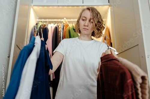 Woman choosing wear in wardrobe photo