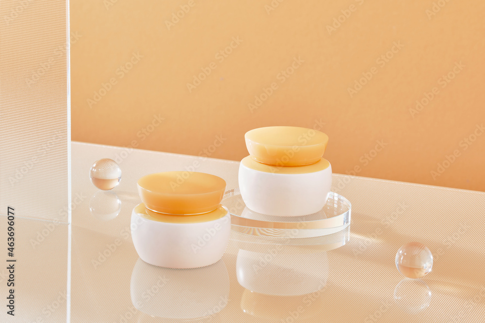 Skin care beauty product on podium with gloss glass on pink background Skin care beauty product on podium with gloss glass on pink background