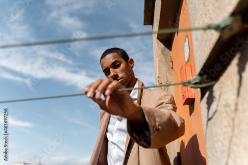 Male black model looking at camera outdoor 