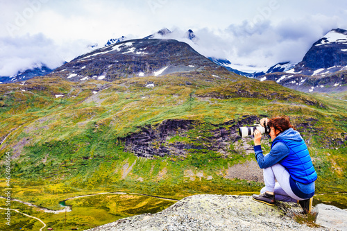 Tourist with camera in Norway mountains