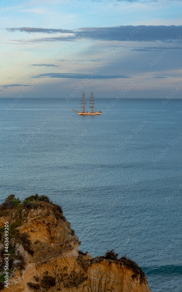 Tall ship on the ocean close to Ponta da Piedade cliffs of Lagos Algarve, Portugal. 