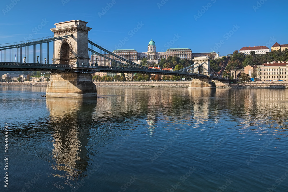 Obraz premium Budapest, Hungary. Szechenyi Chain Bridge across Danube and Royal Palace in sunny autumn morning.