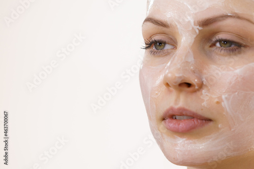 Girl with cream moisture cosmetic on face