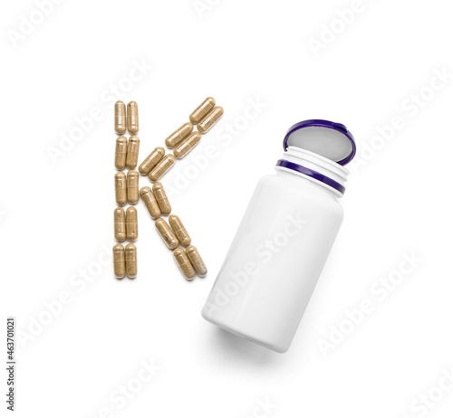 Wallpaper Mural Bottle and letter K made of pills on white background Torontodigital.ca