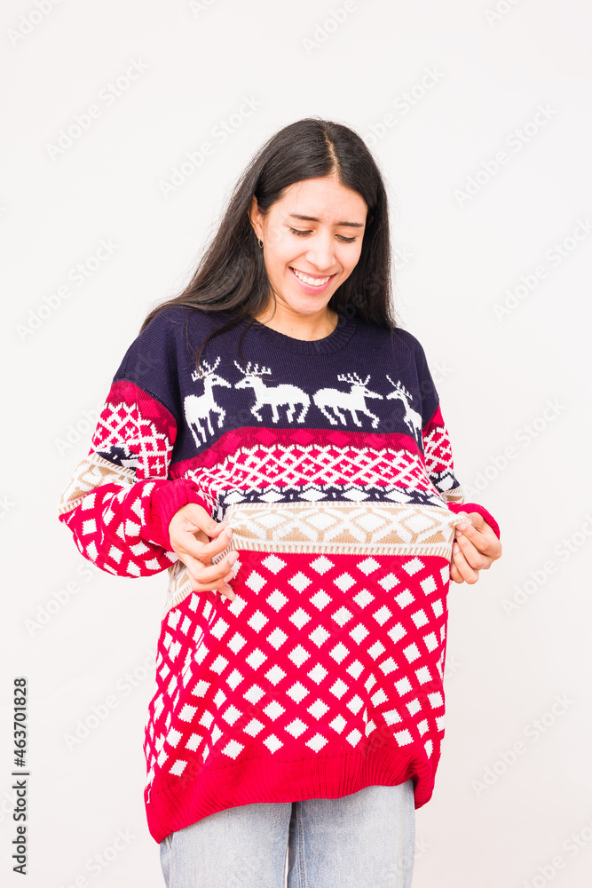 Christmas ugly sweater. Latin venezuelan woman wearing a fashion woolen xmas style Christmas ugly sweater. Latin venezuelan woman wearing a fashion woolen xmas style