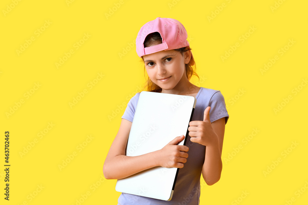 Little programmer with laptop showing thumb-up on color background Little programmer with laptop showing thumb-up on color background