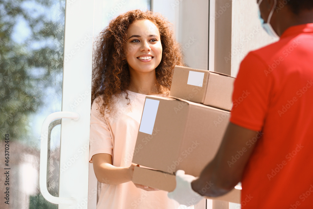 Customer receiving parcel from delivery man Customer receiving parcel from delivery man