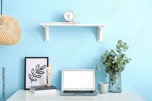 Laptop and vase with eucaly...