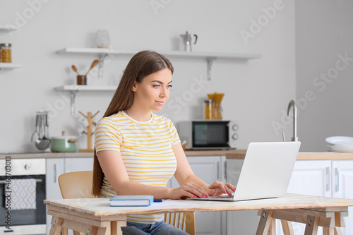 Young woman working with la...
