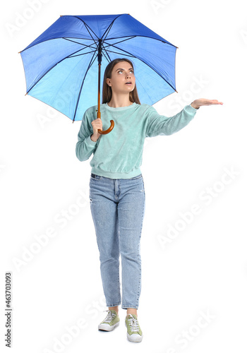Young woman with open blue umbrella on white background © Pixel-Shot