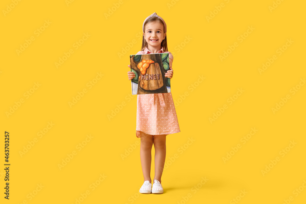 Cute little girl with book on yellow background Cute little girl with book on yellow background