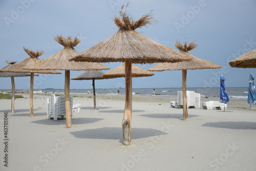 Beautiful view of umbrellas made of straws on the beach in Romania photo