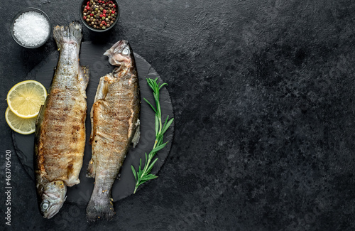 grilled trout on a stone background with copy space for your text