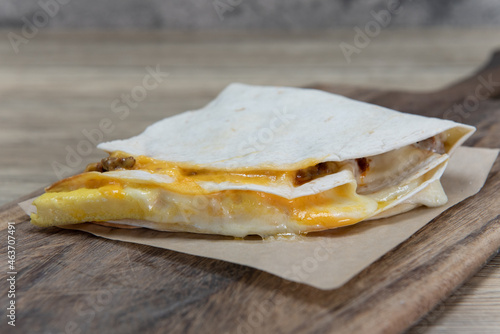 Folded torilla filled with melted cheese for a breakfast treat to start the day photo