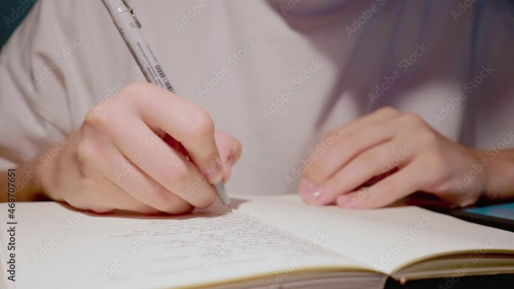 young female hands handwriting in daily journal in slow motion close up young female hands handwriting in daily journal in slow motion close up