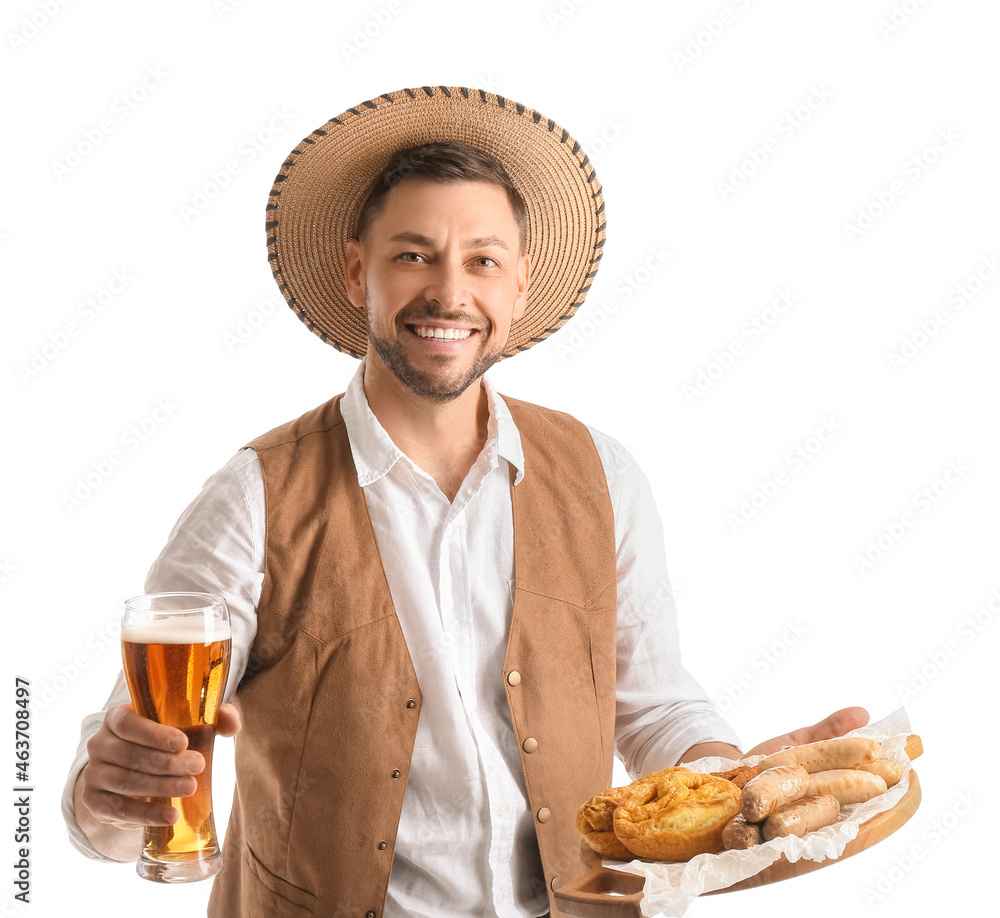 Young man in traditional German clothes with beer and food on white background Young man in traditional German clothes with beer and food on white background