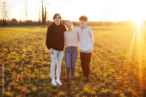 Three young adults / teens outside together. photo