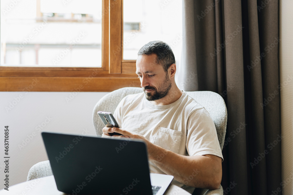 Man with laptop and smartphone at home Man with laptop and smartphone at home