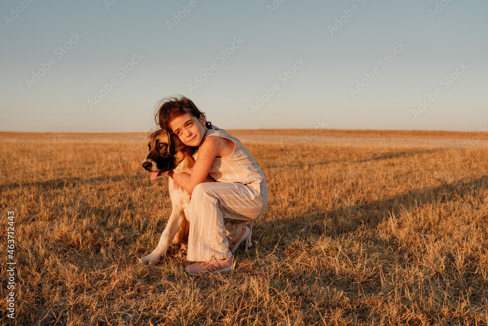 Pretty girl hugging her doggy at field Pretty girl hugging her doggy at field