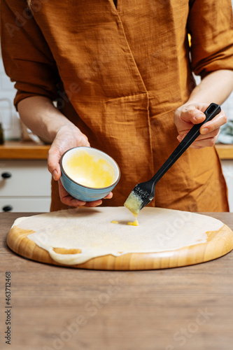 Crop woman chef making Indian flatbread at home