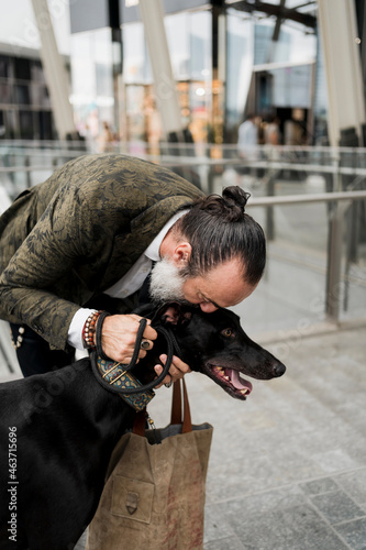 Man kissing his dog outdoor photo