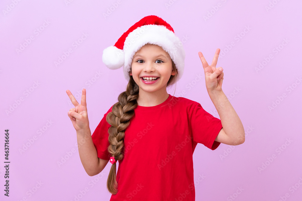a girl in a New Year's hat and a red T-shirt shows her fingers on her hands. a girl in a New Year's hat and a red T-shirt shows her fingers on her hands.