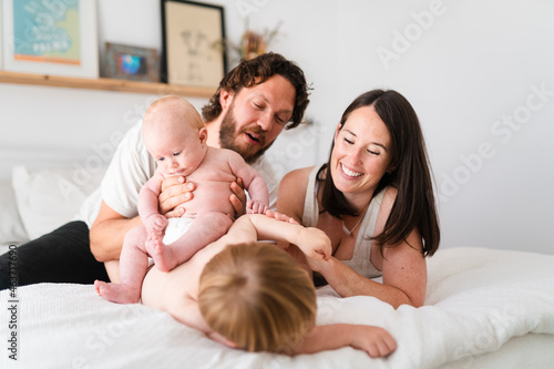 Family hanging out in bed photo