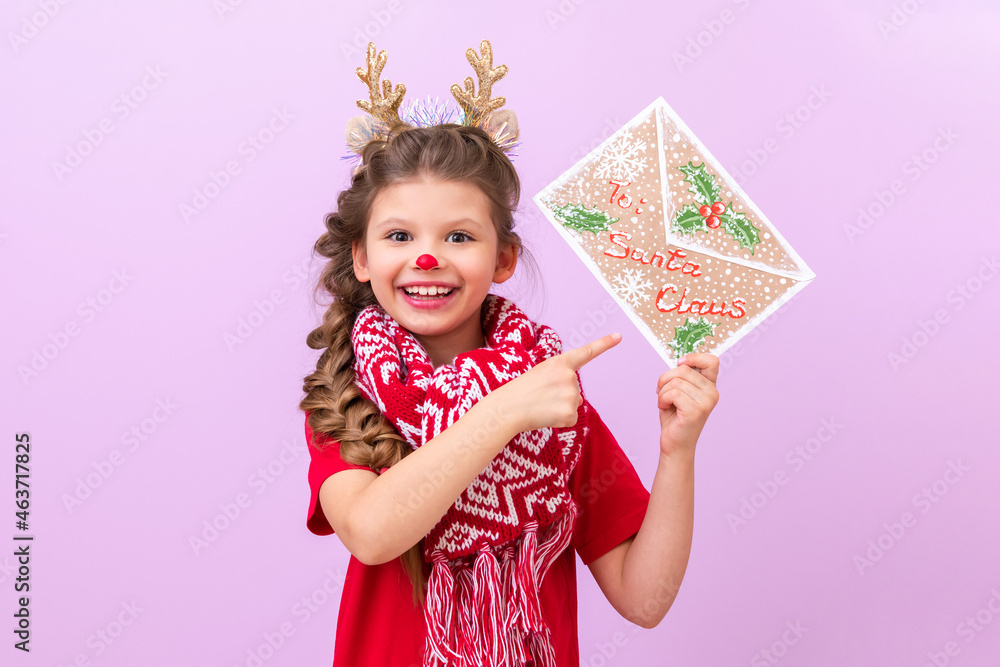 A little girl with deer ears and horns on her head shows a New Year's eve concert. A little girl with deer ears and horns on her head shows a New Year's eve concert.