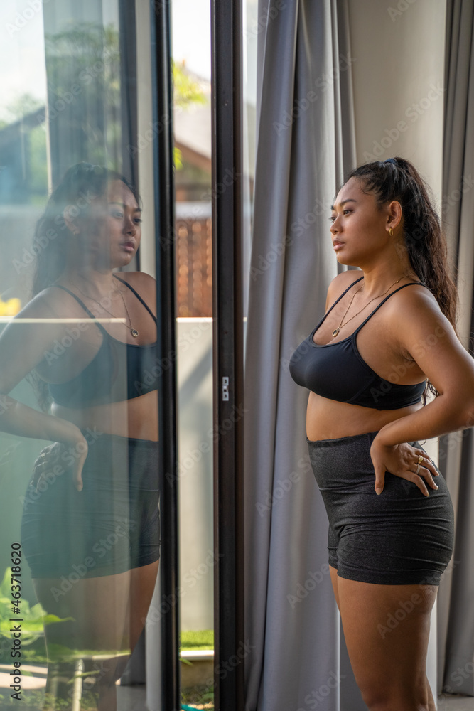 Woman Looking Thoughtfully Out Her Window At Home Woman Looking Thoughtfully Out Her Window At Home
