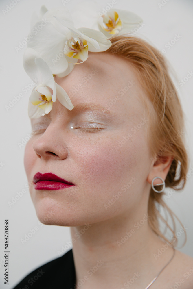portrait of a redhead model with make up and flowers portrait of a redhead model with make up and flowers