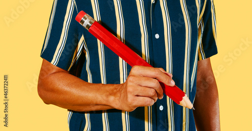 man about to write with a large red pencil photo