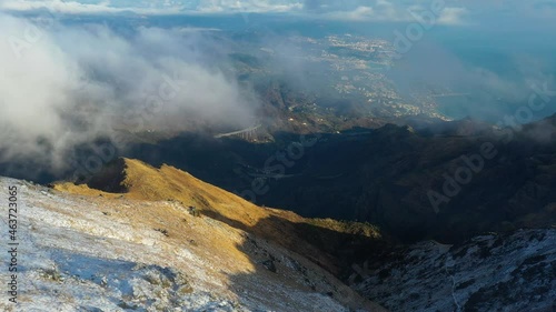 Aerial view from the summit of the Beigua mountain, towards the city of Genova, in Italy - tilt, drone shot photo