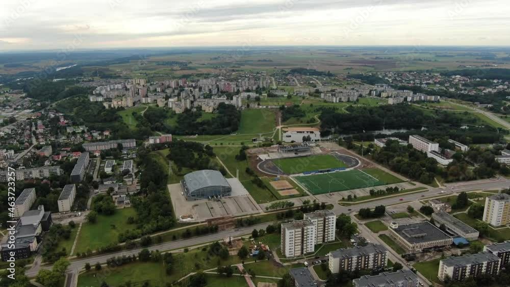 Football field and old block apartment buildings in cityscape of Jonava, aerial drone view Football field and old block apartment buildings in cityscape of Jonava, aerial drone view