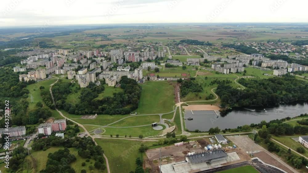 Small water dam in centre of Jonava city with apartment buildings around, high angle drone view Small water dam in centre of Jonava city with apartment buildings around, high angle drone view