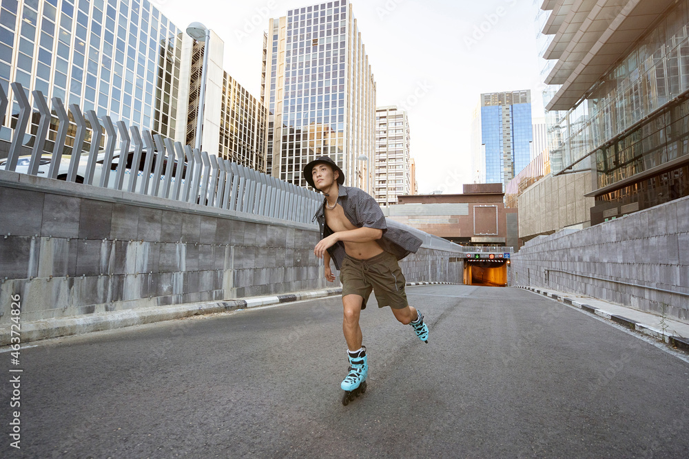Young man roller skating on asphalt in the city Young man roller skating on asphalt in the city