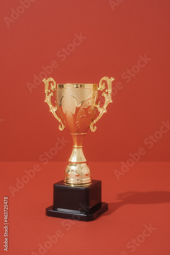 Golden Trophy On Red Background Studio Shot photo