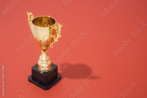 Golden Trophy On Red Background With Copy Space photo