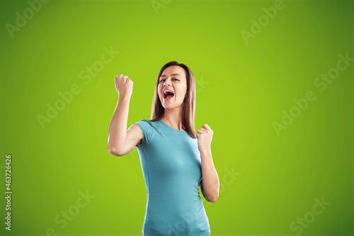 Triumphing cute joyful girl, fist pump celebrating good news,