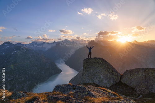 Man standing on rock in the alps. photo