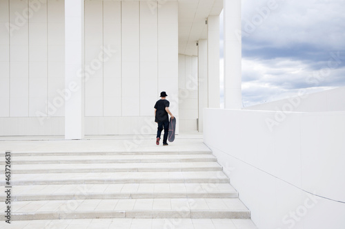 Skateboarder on a white building background  photo