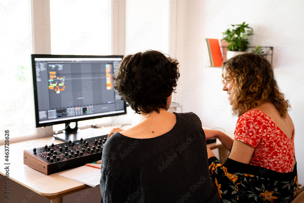 © Alba Vitta/Stocksy - Musician Friends recording music at home studio