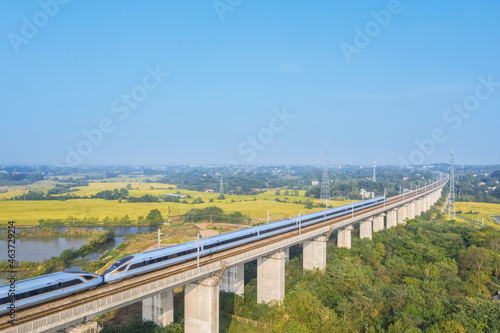 aerial view of high speed trains in rural autumn landscape