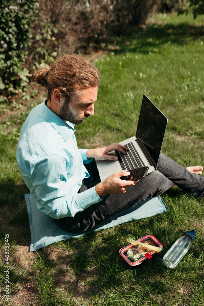A young busy businessman has a lunch break outdoor. A young busy businessman has a lunch break outdoor.