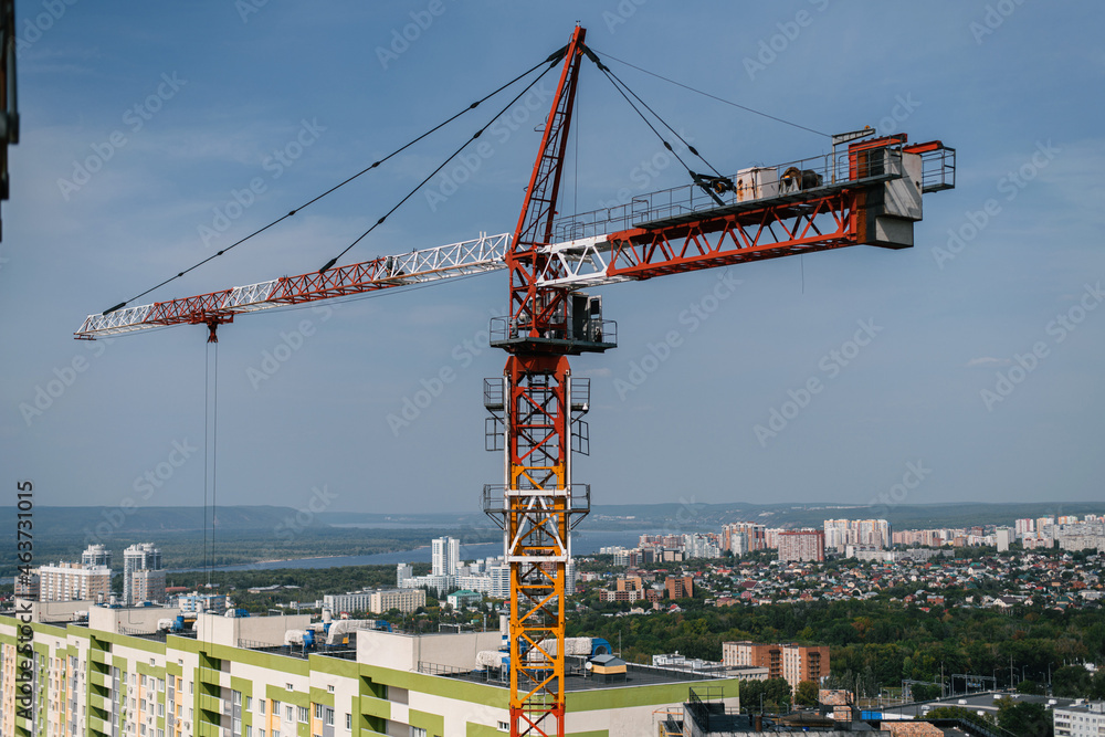 giant building crane above the city line on a sunny day giant building crane above the city line on a sunny day