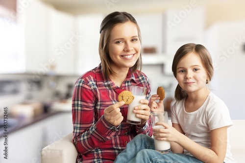 Healthy Breakfast. Cute Little Girl And Her Smiling mother Eating Homemade Cookies