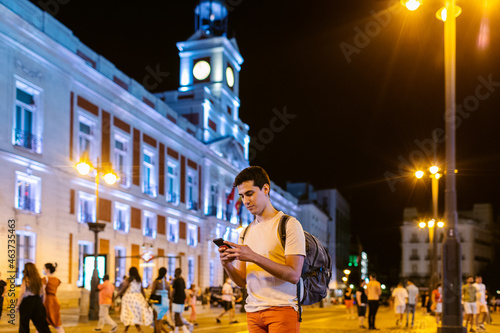 Student with smartphone in evening city