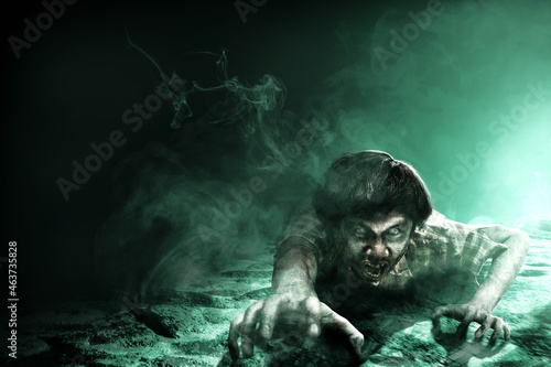 Scary zombie with blood and wound on his body crawling © Leo Lintang