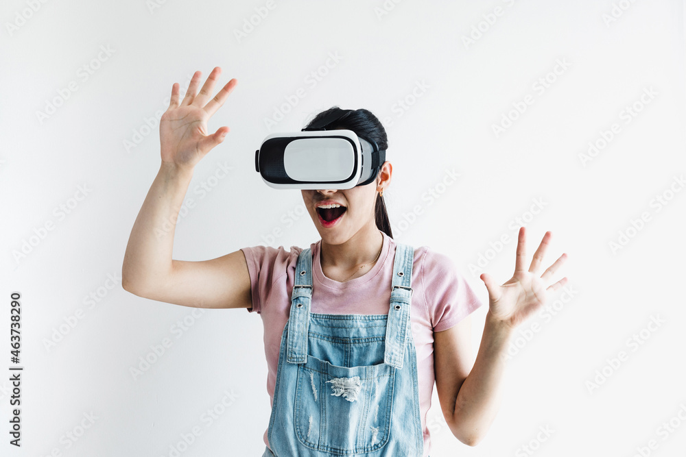 young latin woman with glasses of virtual reality on a white background. Future technology concept. Modern imaging technology in Latin America young latin woman with glasses of virtual reality on a white background. Future technology concept. Modern imaging technology in Latin America