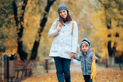 Happy Mom and Child Walking in the Park in Autumn Season © nicoletaionescu